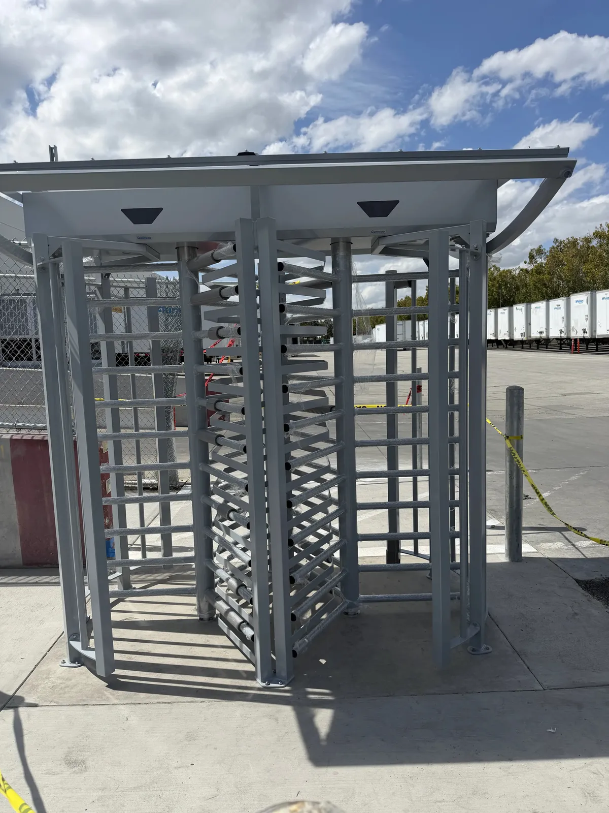 Full-height turnstile with an overhead canopy at the entrance to a trailer yard