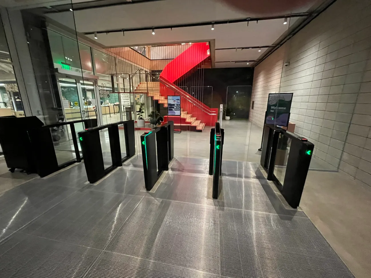Optical speed gates installed across a corporate lobby entry, green pass indicators lit