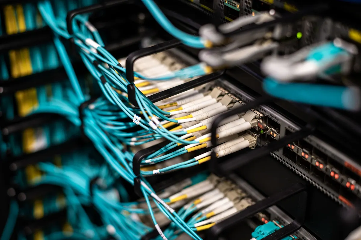 Fiber patch cables terminated into a structured cabling patch panel