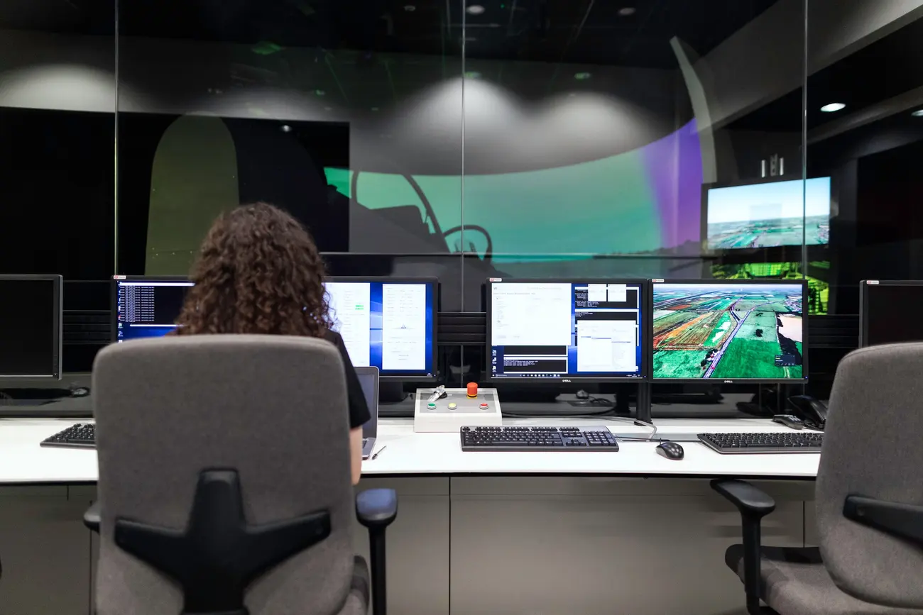 Operator reviewing live camera feeds at a multi-screen monitoring console